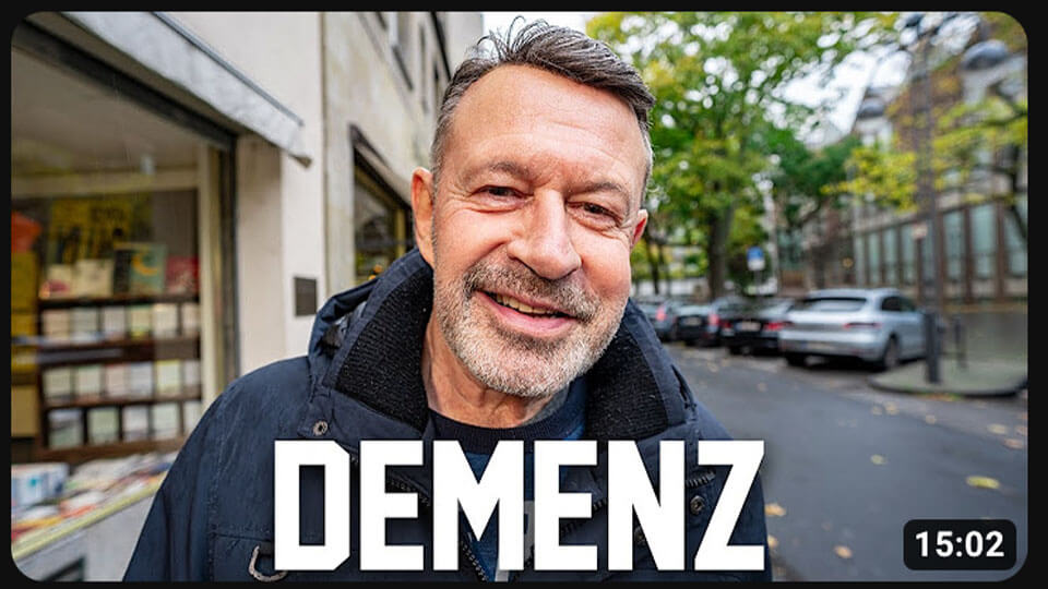 Ein Thumbnail mit einem Mann mittleren Alter, der in die Kamera lächelt. Unten steht das Schlagwort "Demenz"